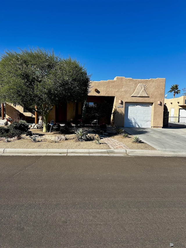 pueblo-style home with a garage