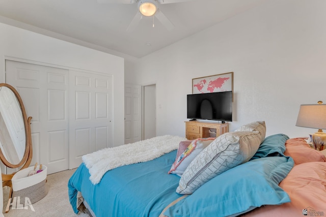 bedroom with light colored carpet, ceiling fan, and a closet