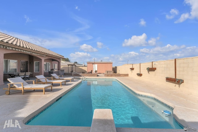 view of pool featuring a patio area and a diving board