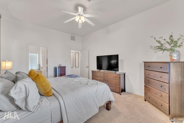 carpeted bedroom with connected bathroom and ceiling fan