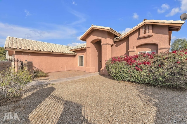 mediterranean / spanish home featuring a patio area