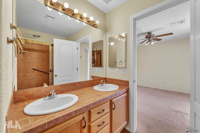 bathroom with double vanity, a sink, and visible vents