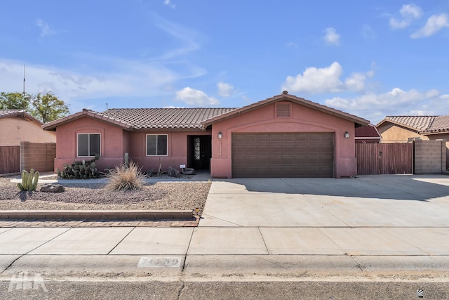 ranch-style home featuring a garage, driveway, and stucco siding