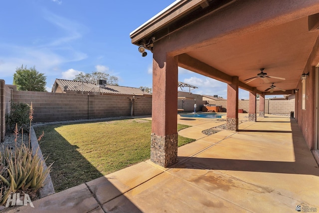 view of yard with a patio area, a fenced backyard, and a ceiling fan