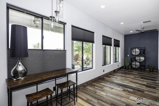 interior space featuring ceiling fan and dark hardwood / wood-style flooring