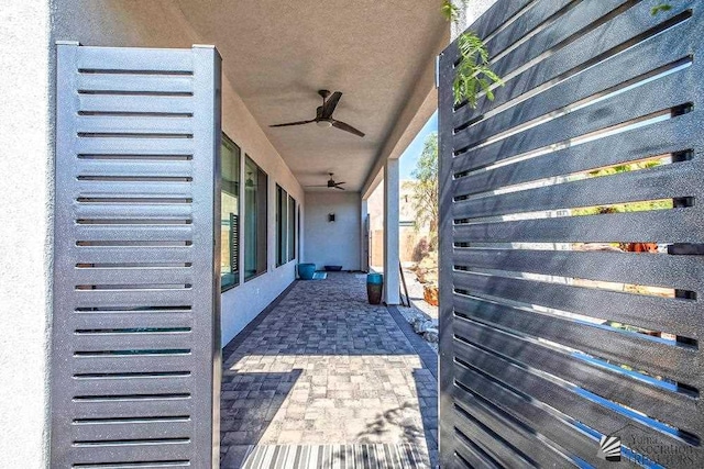 view of side of property featuring ceiling fan and a patio