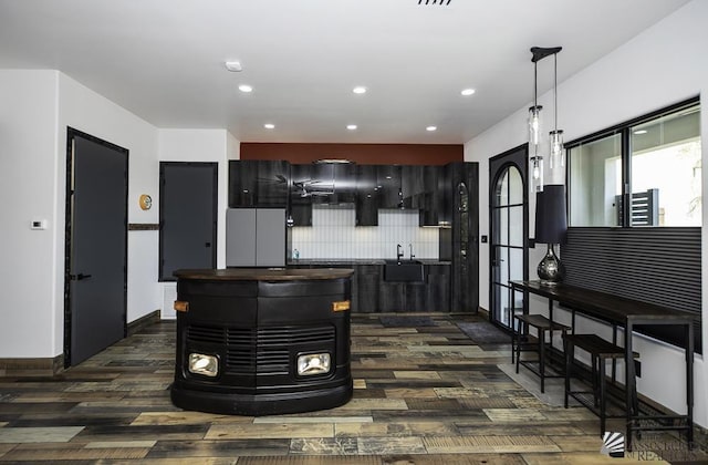 kitchen with dark hardwood / wood-style floors, backsplash, and sink