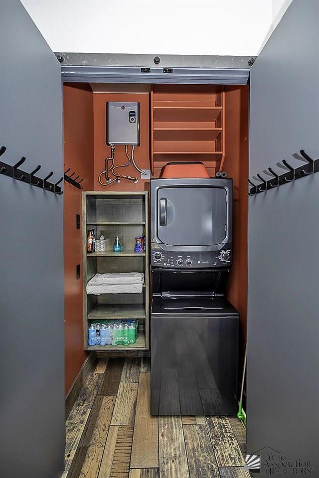 interior space featuring wood-type flooring and stacked washer and clothes dryer