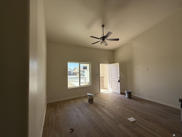 unfurnished bedroom featuring dark wood-type flooring, ceiling fan, and baseboards