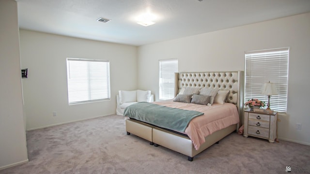 bedroom with light colored carpet