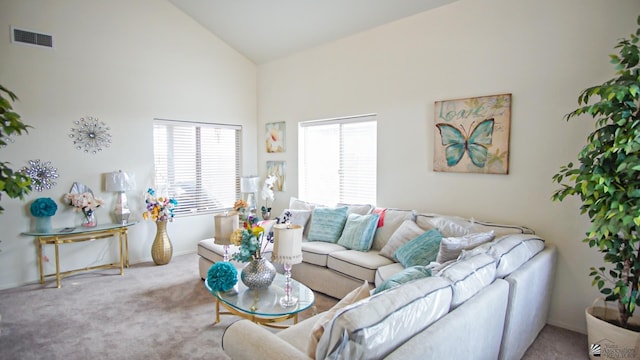 carpeted living room featuring high vaulted ceiling