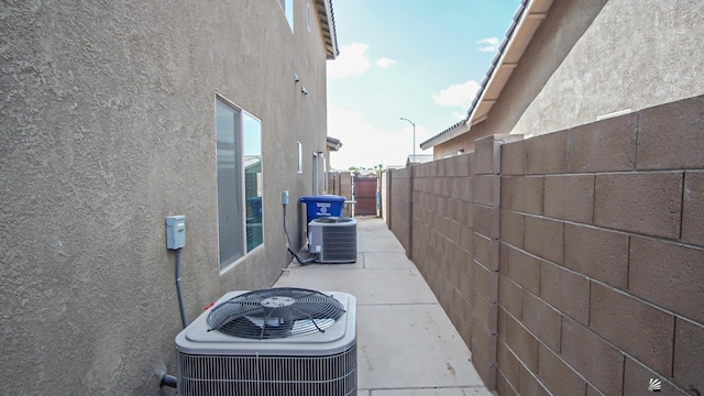 view of home's exterior with cooling unit and a patio area