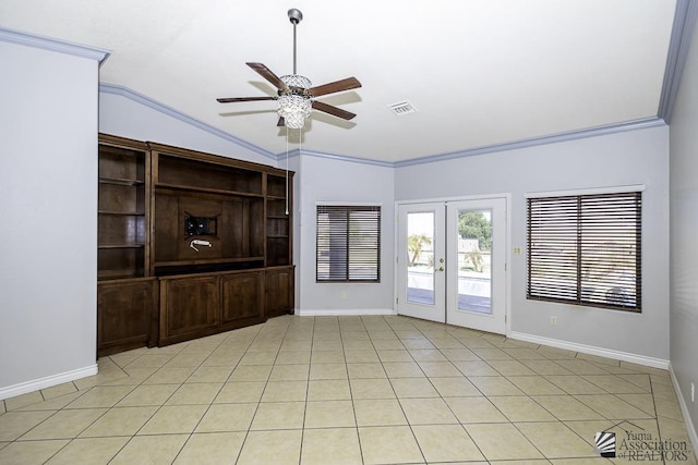 spare room with lofted ceiling, crown molding, french doors, and ceiling fan