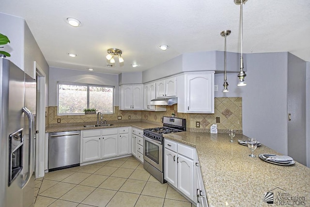 kitchen featuring pendant lighting, sink, white cabinets, and appliances with stainless steel finishes