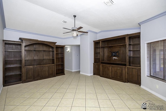 unfurnished living room with ceiling fan, ornamental molding, vaulted ceiling, and light tile patterned floors