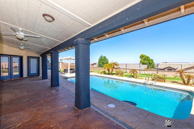 view of pool featuring a patio, ceiling fan, and french doors