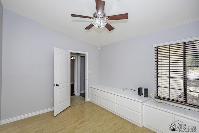 unfurnished bedroom with vaulted ceiling, ceiling fan, and light hardwood / wood-style flooring