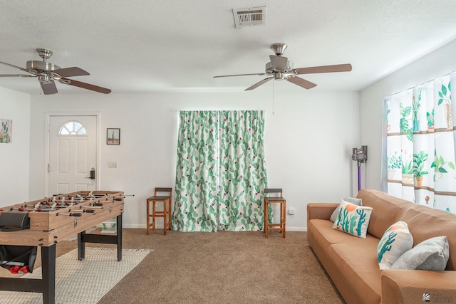 carpeted living room with a textured ceiling and ceiling fan