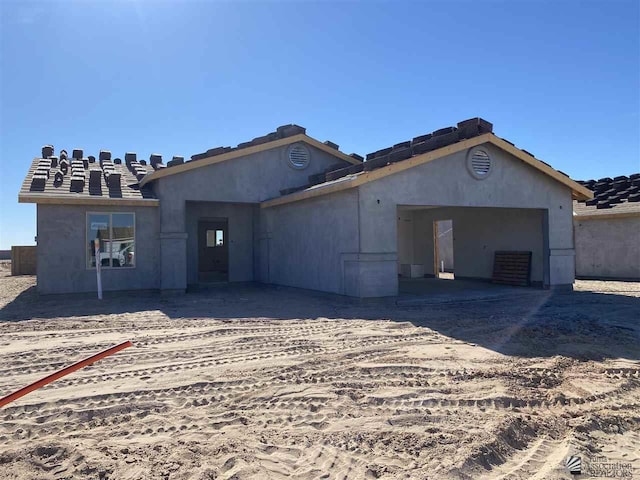 view of front of home with stucco siding and an attached garage