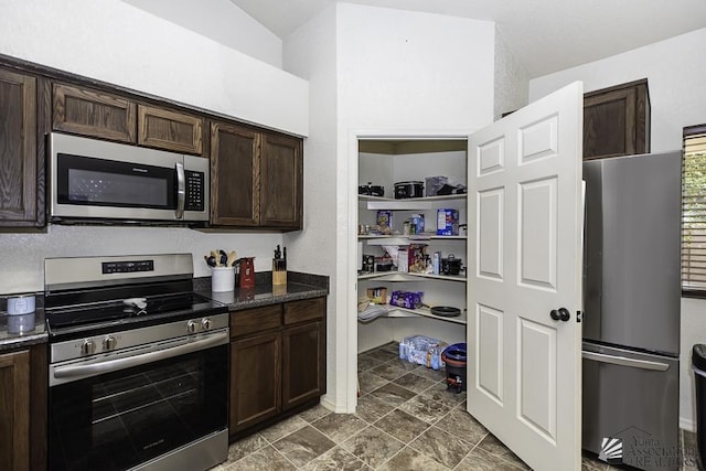 kitchen featuring dark brown cabinetry and appliances with stainless steel finishes