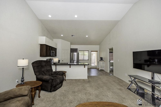 carpeted living room featuring recessed lighting and high vaulted ceiling