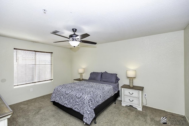 carpeted bedroom featuring visible vents and ceiling fan