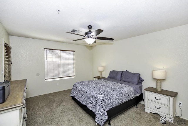 carpeted bedroom with visible vents and ceiling fan