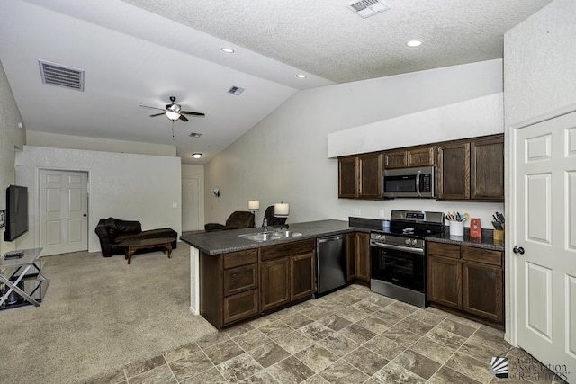 kitchen with a sink, visible vents, appliances with stainless steel finishes, and a peninsula