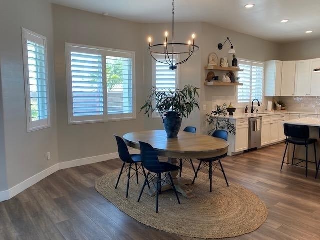 dining room with sink, dark wood-type flooring, and a wealth of natural light