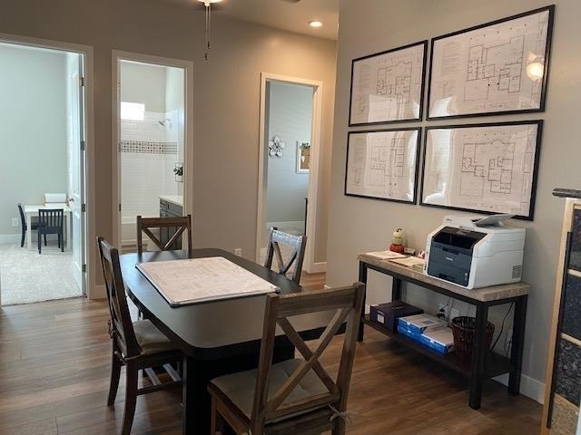 dining space with dark hardwood / wood-style flooring