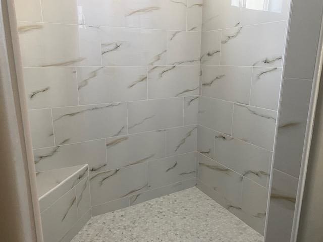 bathroom with a tile shower