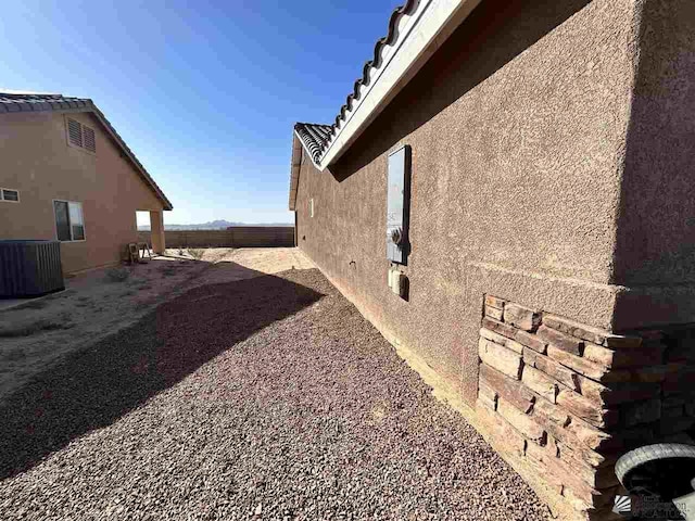 view of side of home featuring central air condition unit