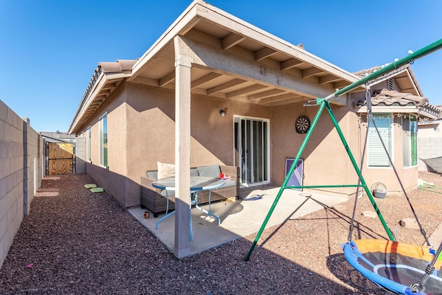 back of house with a patio