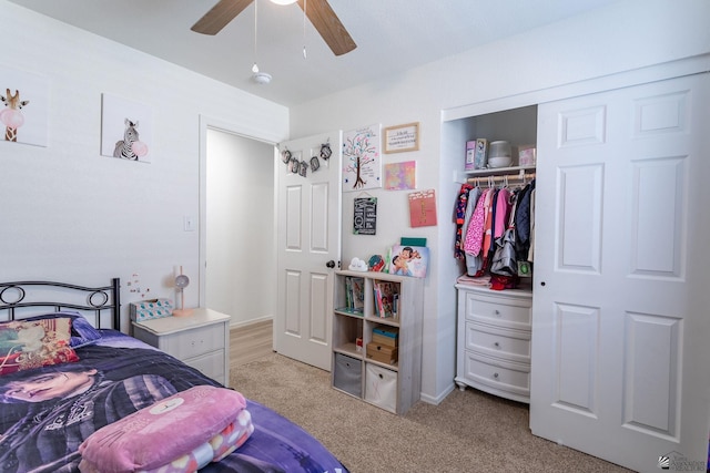 bedroom with a closet, ceiling fan, and light colored carpet