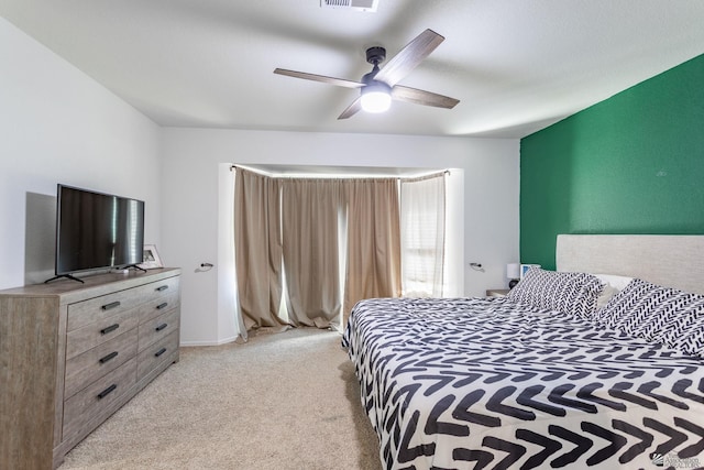 bedroom with ceiling fan and light colored carpet