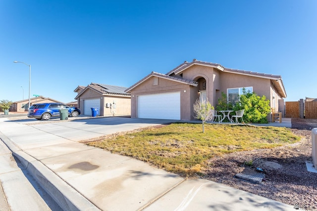 view of front of property with a front yard and a garage