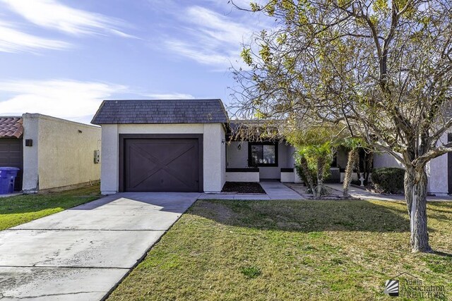 view of front of home with a garage and a front yard