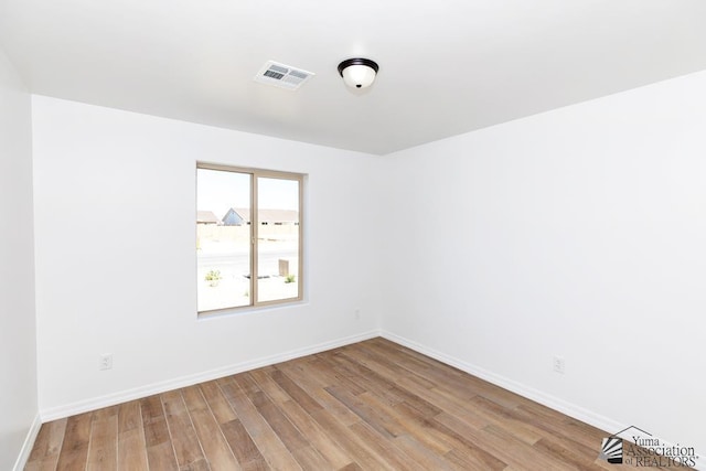 empty room with light hardwood / wood-style flooring