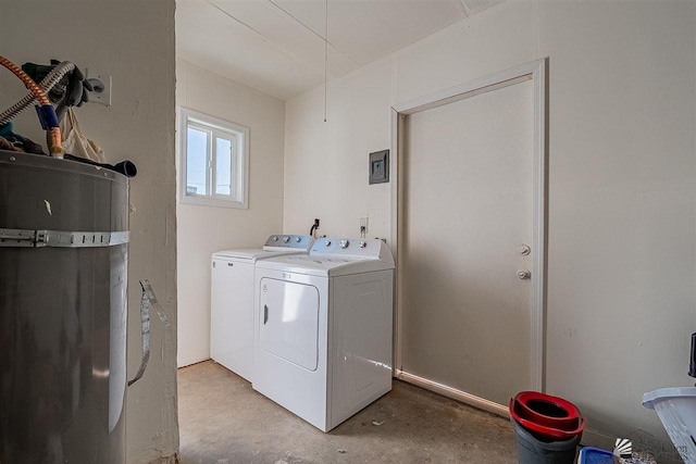 clothes washing area with strapped water heater and independent washer and dryer