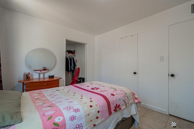 bedroom featuring light tile patterned floors and a closet