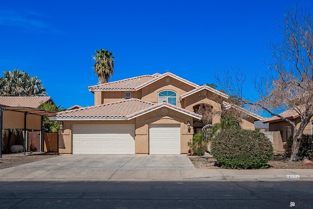 mediterranean / spanish house with a tile roof, stucco siding, an attached garage, fence, and driveway