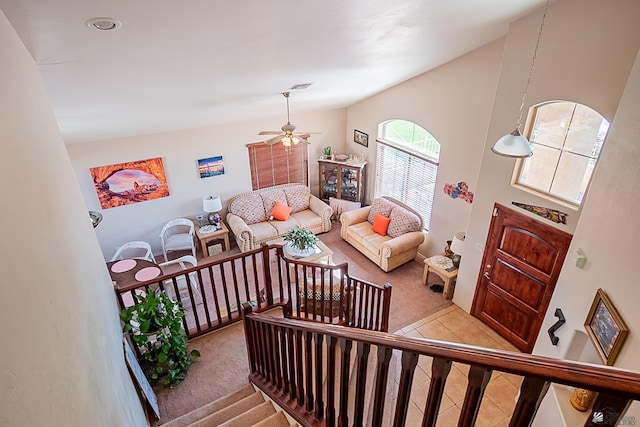 living area featuring a ceiling fan, light colored carpet, visible vents, and light tile patterned flooring