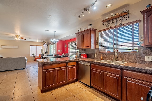 kitchen with light tile patterned floors, dishwasher, backsplash, a peninsula, and a sink