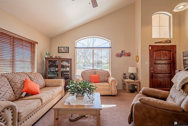 carpeted living room with high vaulted ceiling and ceiling fan