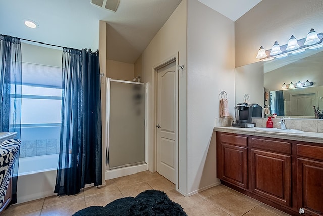 full bath with a stall shower, vanity, and tile patterned floors