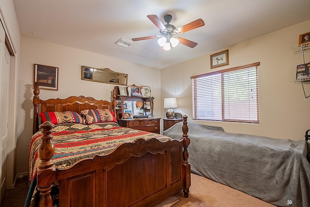 bedroom with carpet, visible vents, and ceiling fan