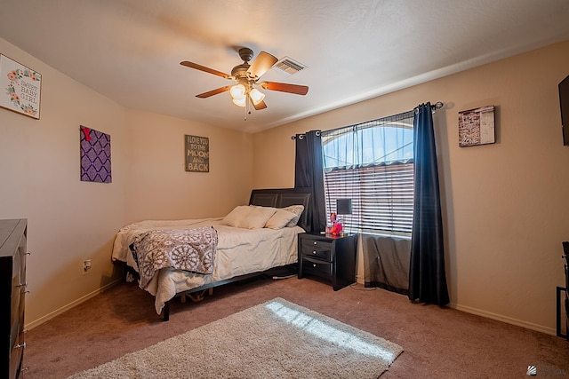 bedroom with light carpet, visible vents, baseboards, and a ceiling fan