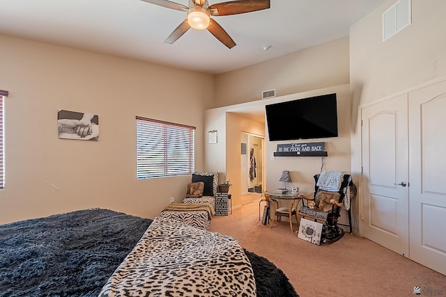 bedroom with visible vents, ceiling fan, and carpet flooring