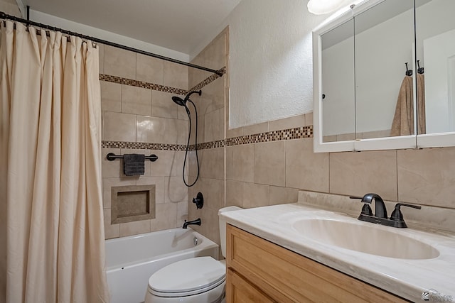 full bath with tile walls, toilet, shower / bath combo with shower curtain, a textured wall, and vanity