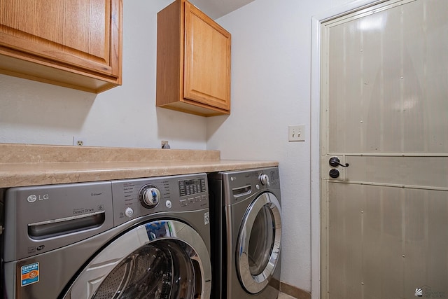 laundry area with cabinet space and separate washer and dryer